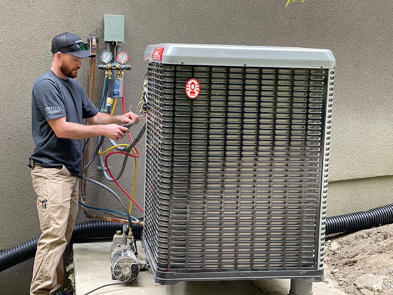 A technician installing a heat pump unit.