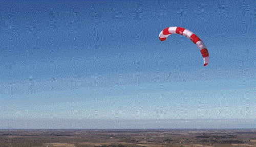 A GIF shows the looping flight of a SkySails paraglider-type red kite as it generates electricity.