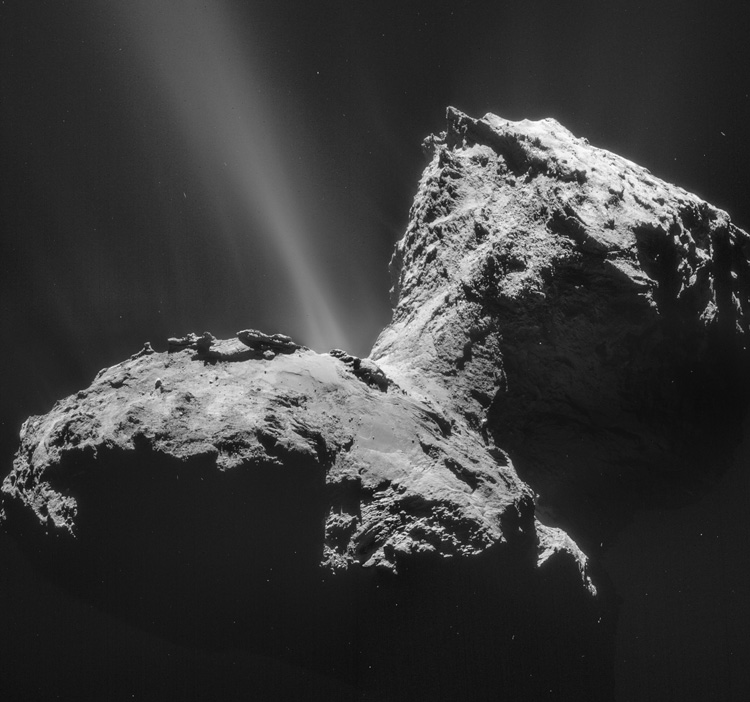 A four-image mosaic comprises images taken 28 km from the center of Comet 67P/Churyumov-Gerasimenko in 2015. The image shows the comet’s larger lobe (bottom) and smaller lobe (top right), as well as a prominent jet and other outflows.