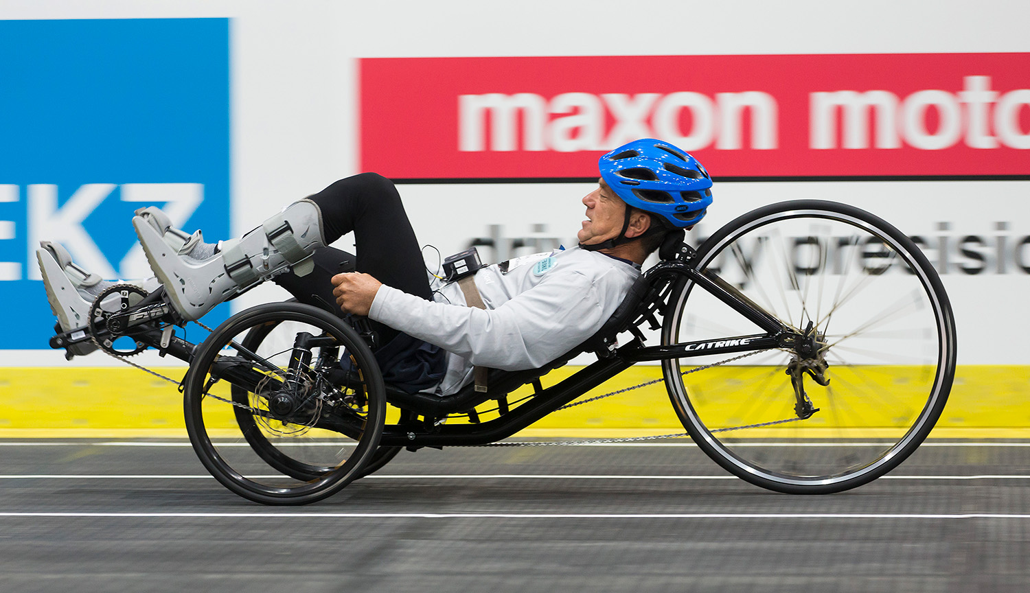 A man rides a reclined bike race around a track